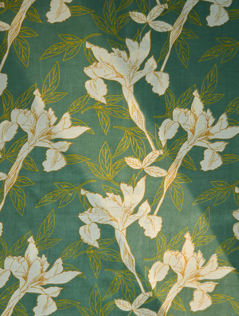 Floral pattern with white flowers and green leaves on a green background