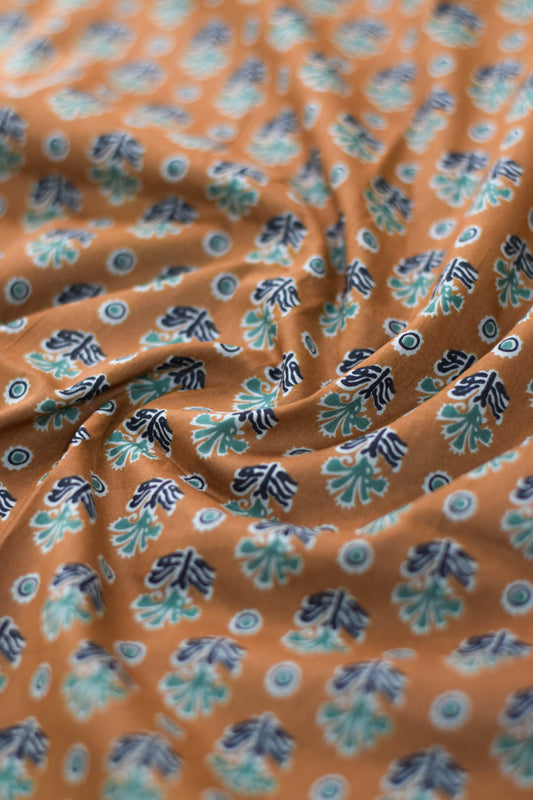 Close-up of floral patterned fabric with light brown background