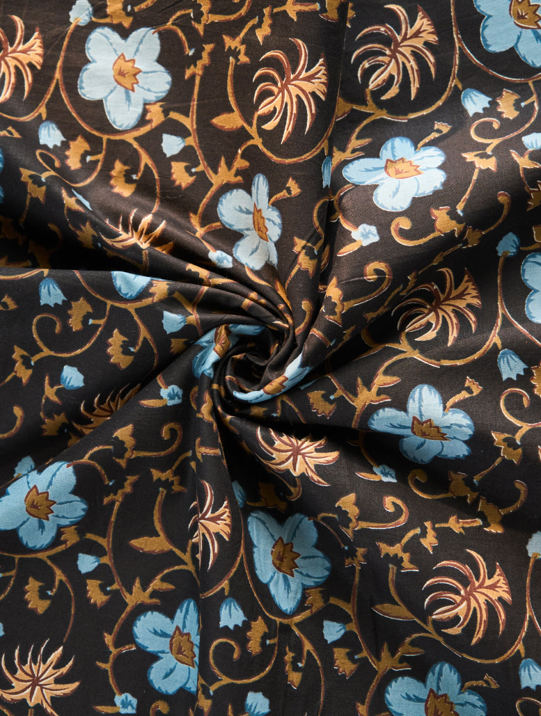 Floral patterned fabric with blue and orange flowers on a brown background