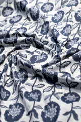 Floral patterned fabric with blue flowers on a white background
