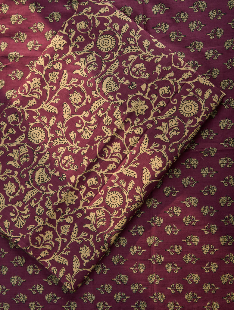 Maroon fabric with gold floral patterns