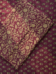 Maroon fabric with gold floral patterns