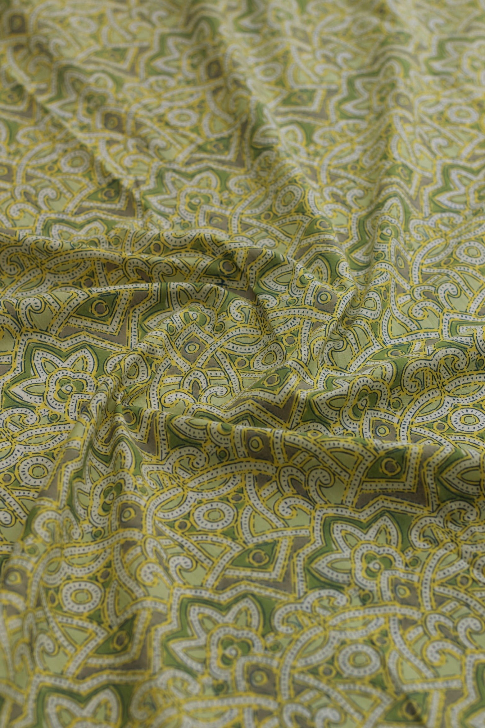 Green fabric with intricate paisley pattern