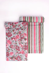 A suit set with one piece featuring a floral pattern and another with a striped pattern in pastel colors.