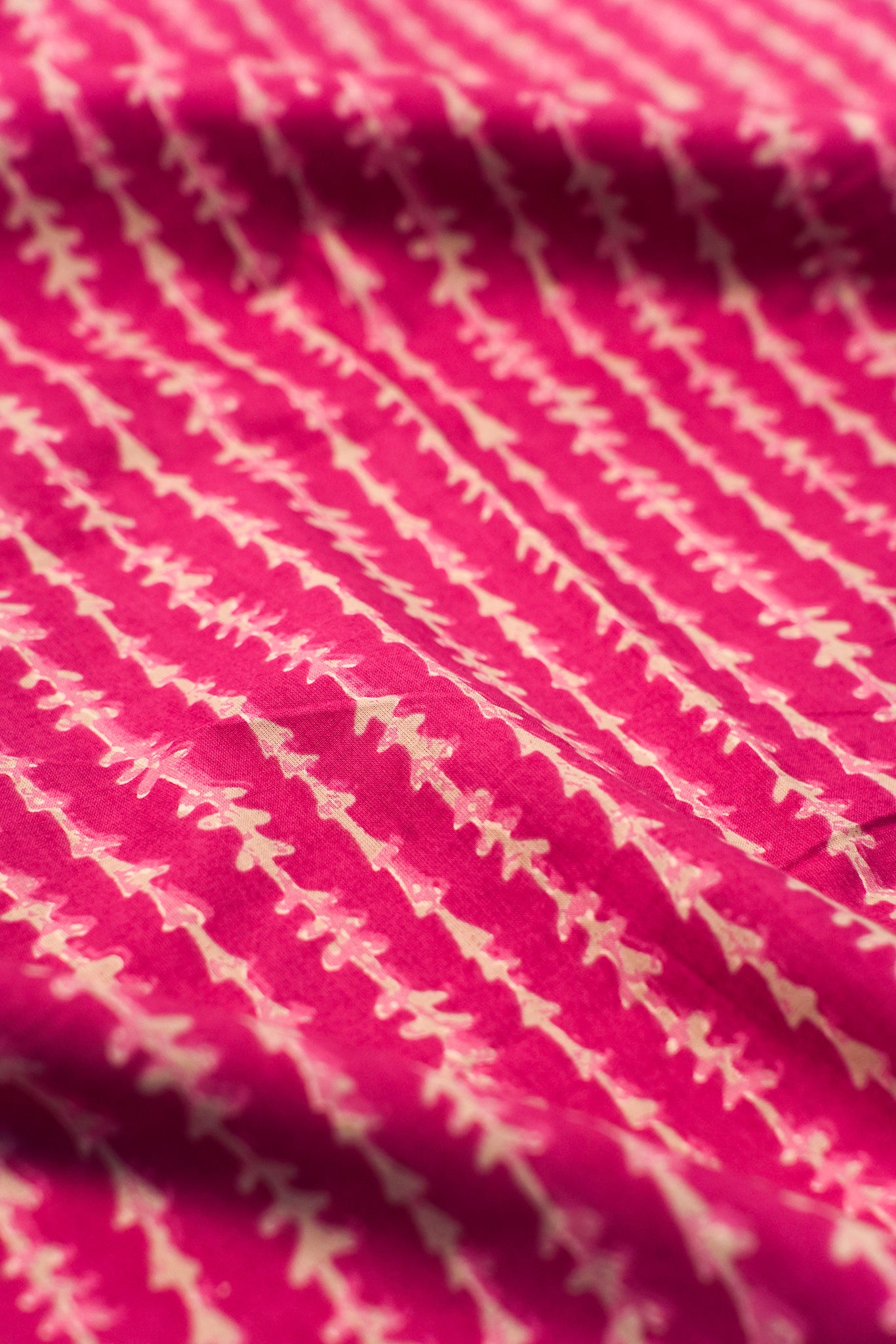 Close-up of pink fabric with white geometric pattern