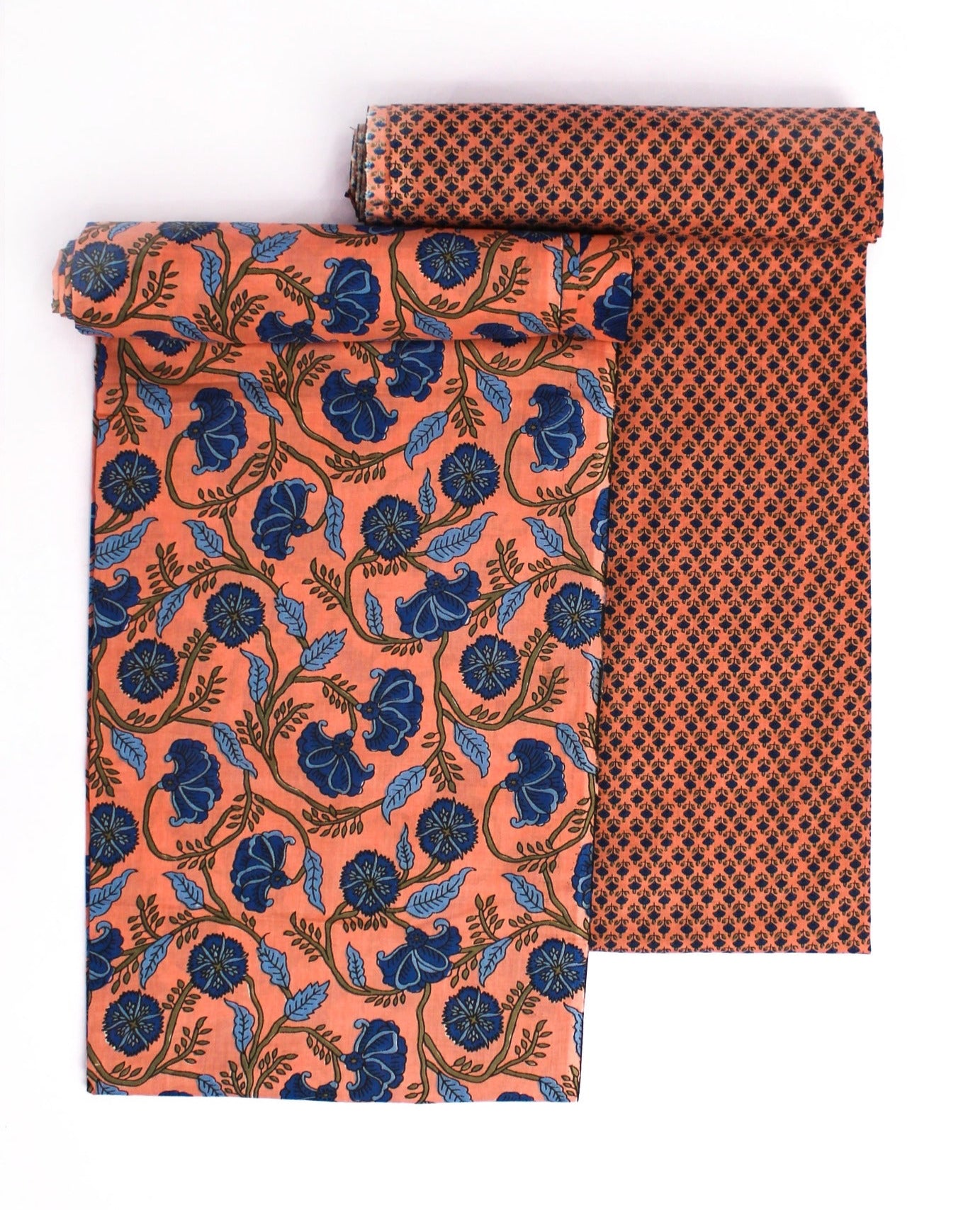 Two fabric rolls with floral and geometric patterns on a white background