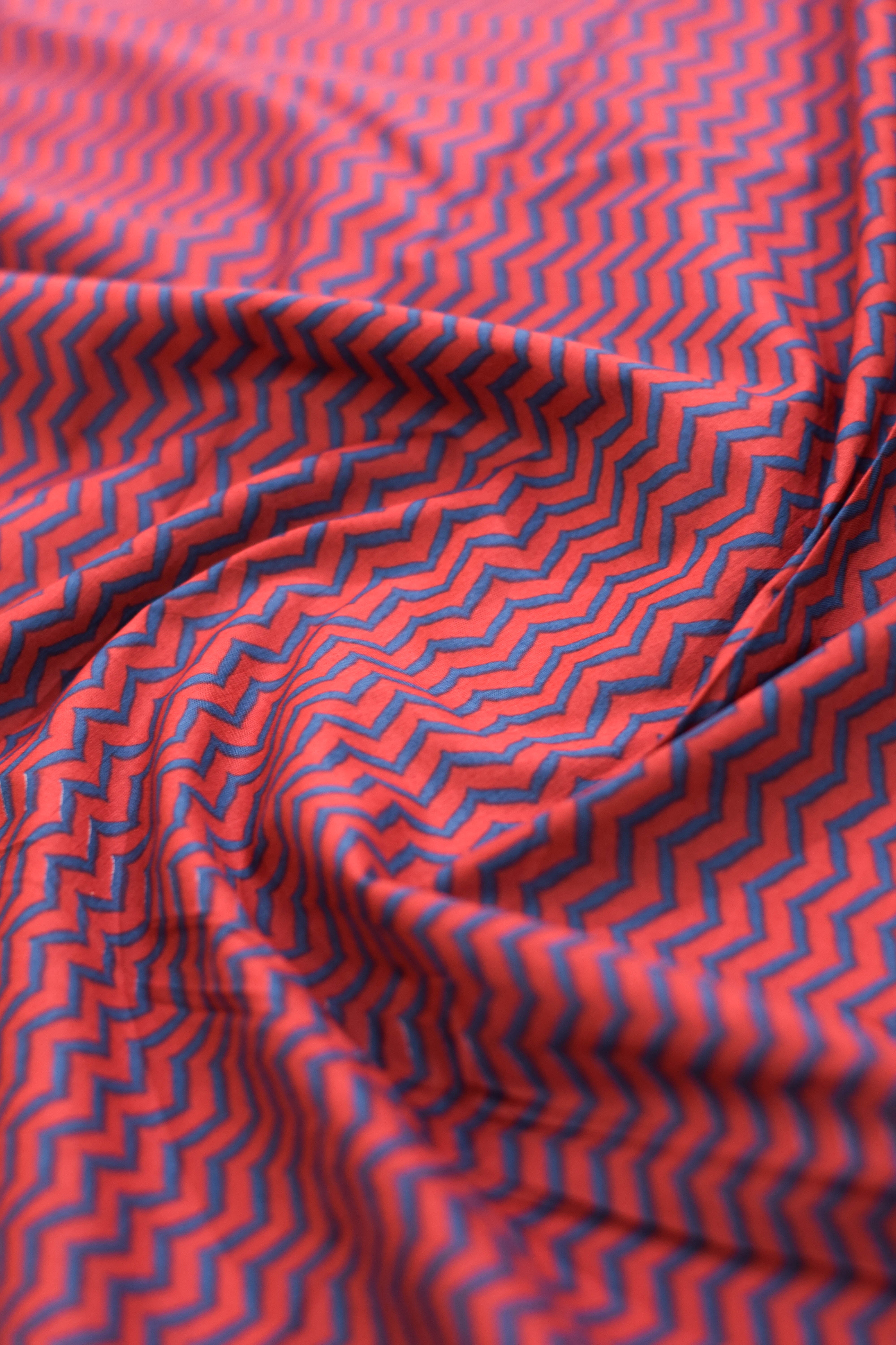Red fabric with blue zigzag pattern