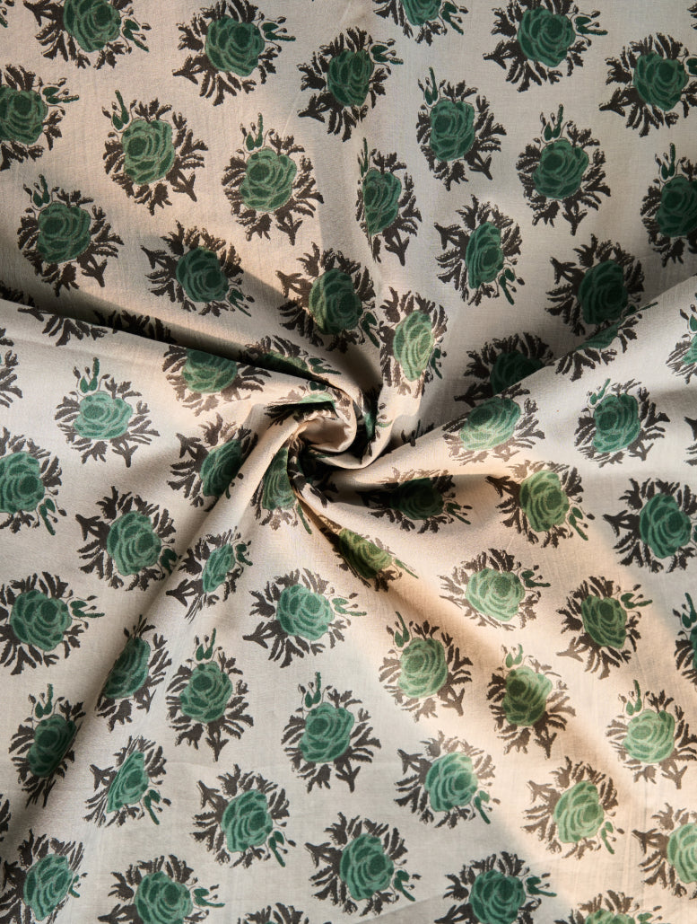 Fabric with green floral pattern on beige background