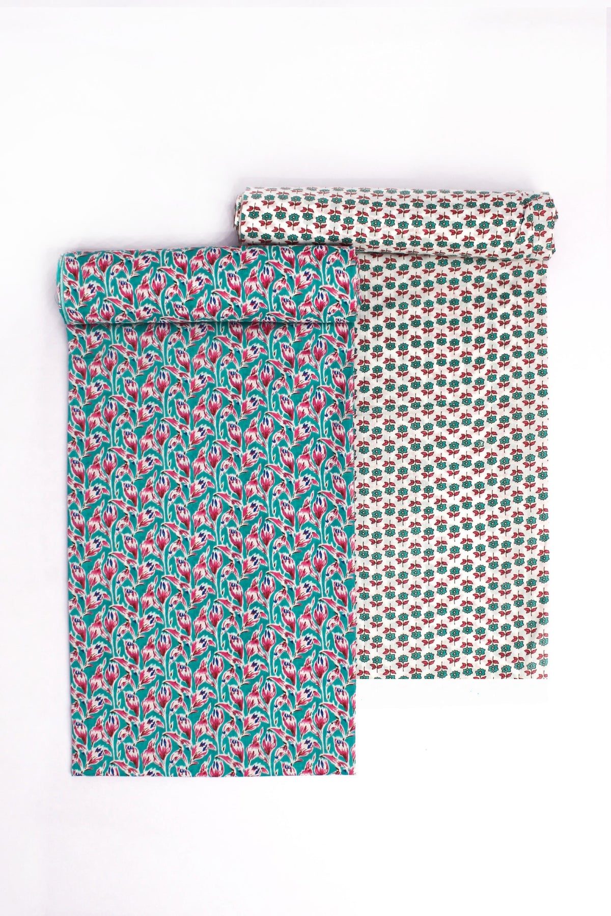 Two pieces of fabric with floral patterns in shades of blue and pink.