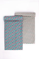 Two pieces of fabric with floral patterns in shades of blue and pink.