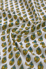 Close-up of patterned fabric with blue and yellow designs on a white background.
