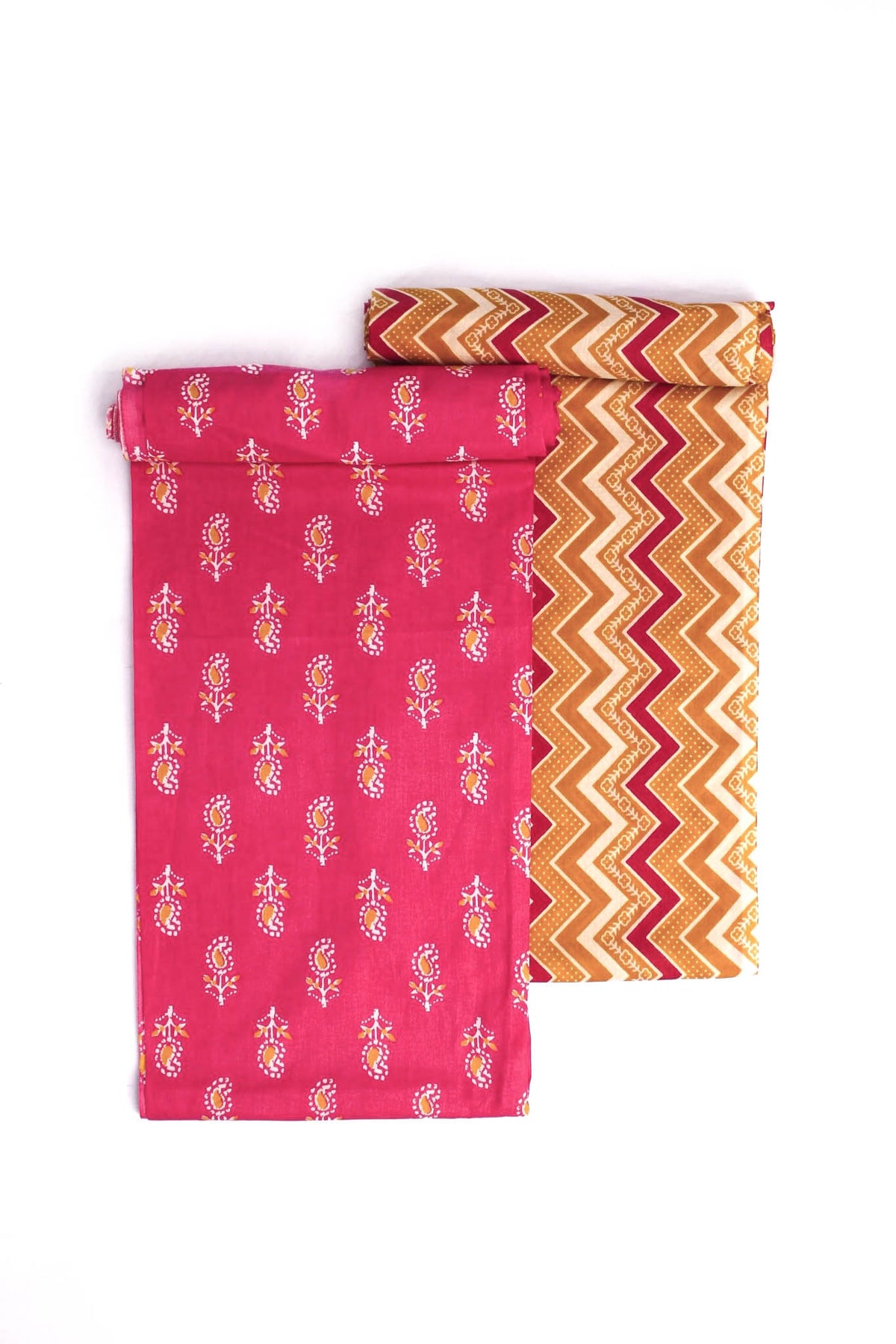 Two fabric swatches, one with a vibrant pink floral pattern and another with a mustard yellow geometric zigzag pattern.