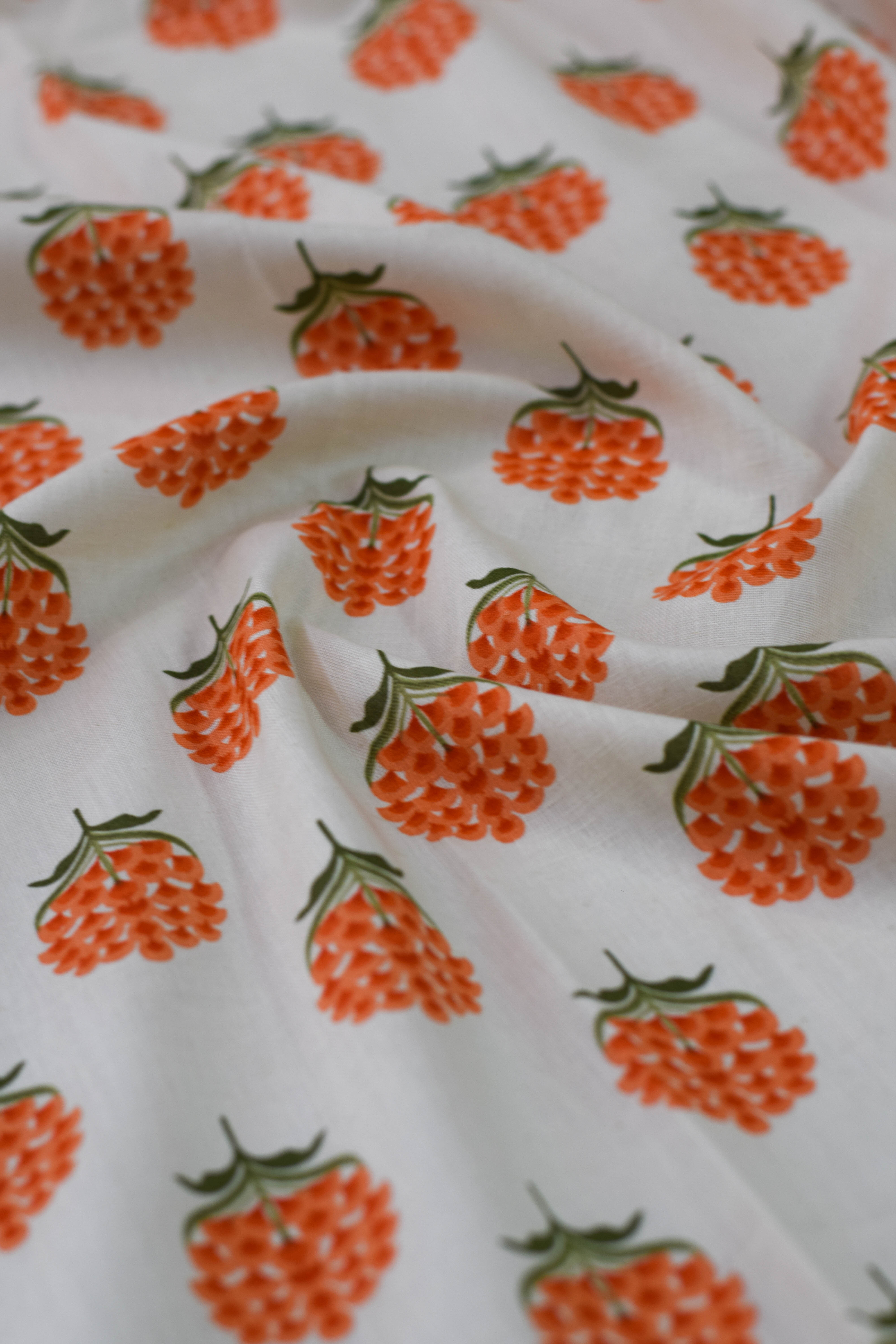 Fabric with orange raspberry pattern on white background