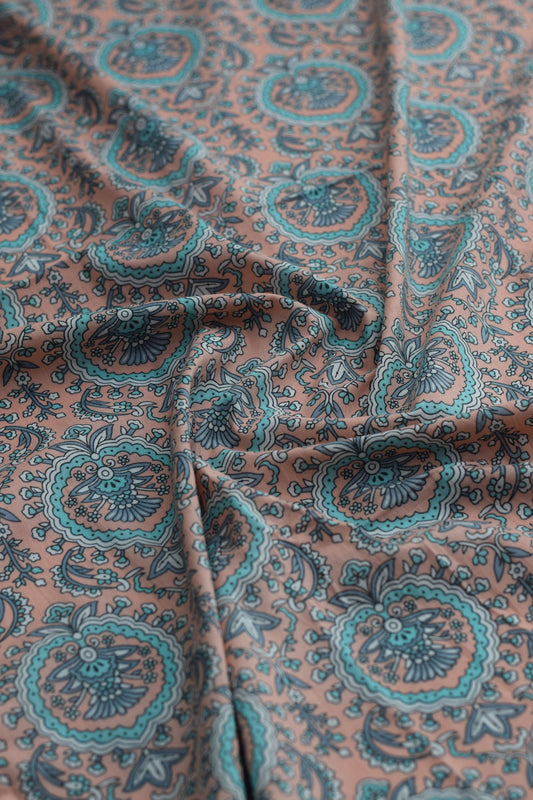Close-up of paisley-patterned fabric in brown and teal.